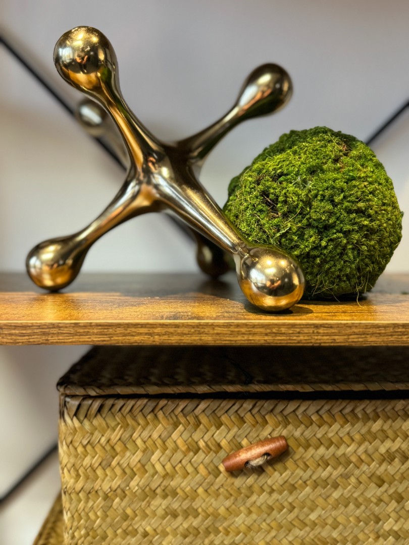 An oversized Jack sitting on a shelf with a ball of moss
